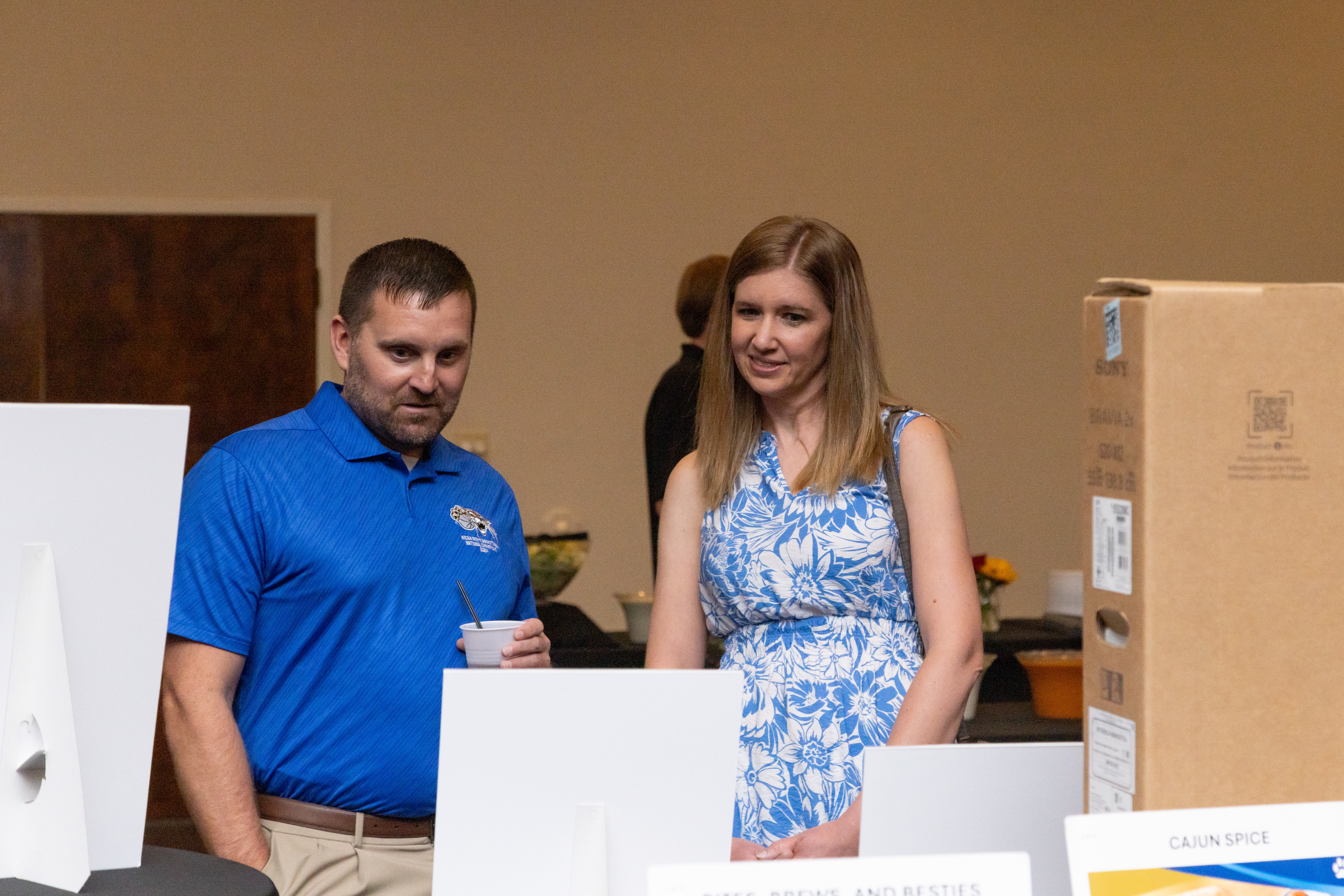 Attendees browse auction items during the Barton Foundation’s 46th Annual Big Benefit Auction