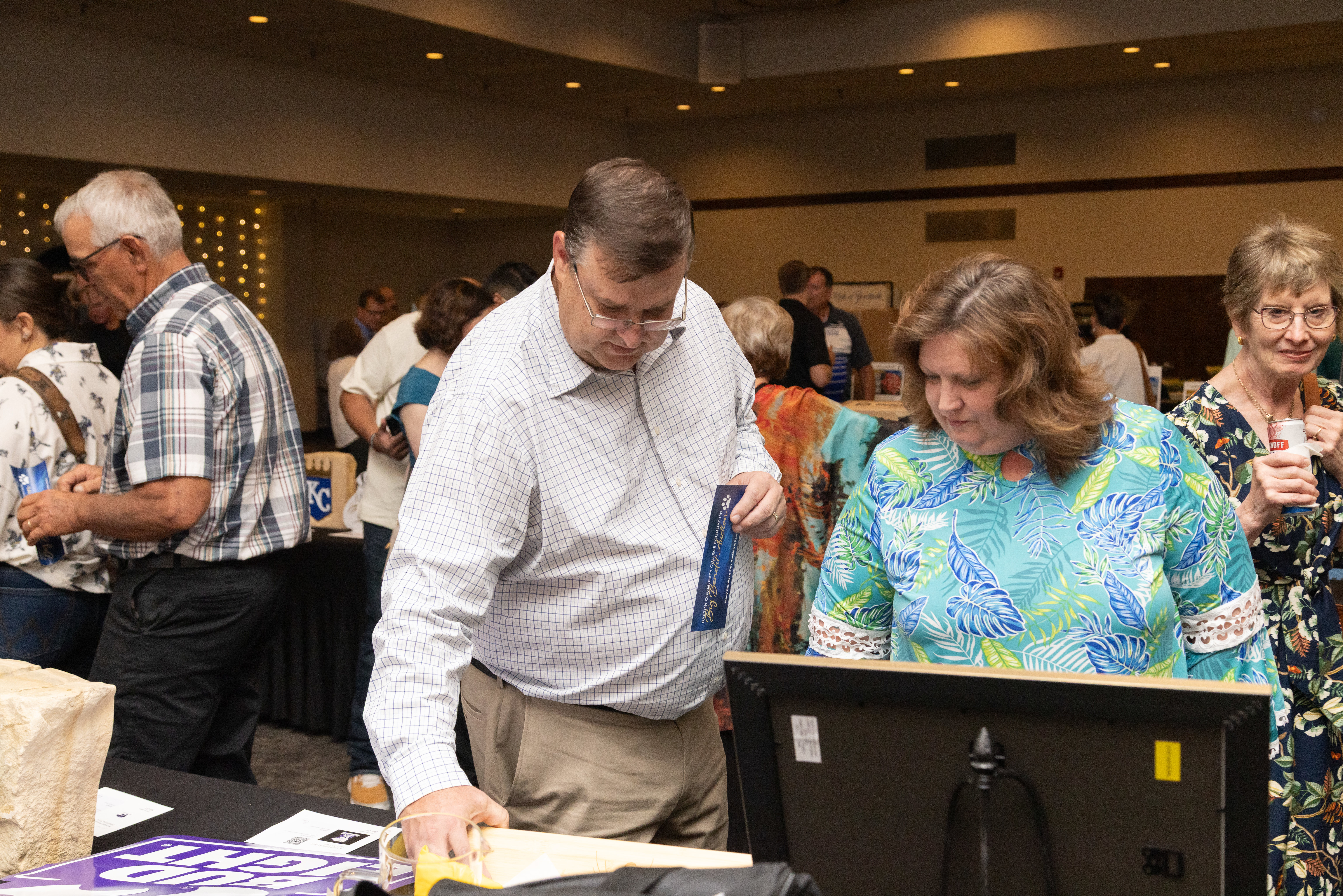 Attendees browse auction items during the Barton Foundation’s 46th Annual Big Benefit Auction