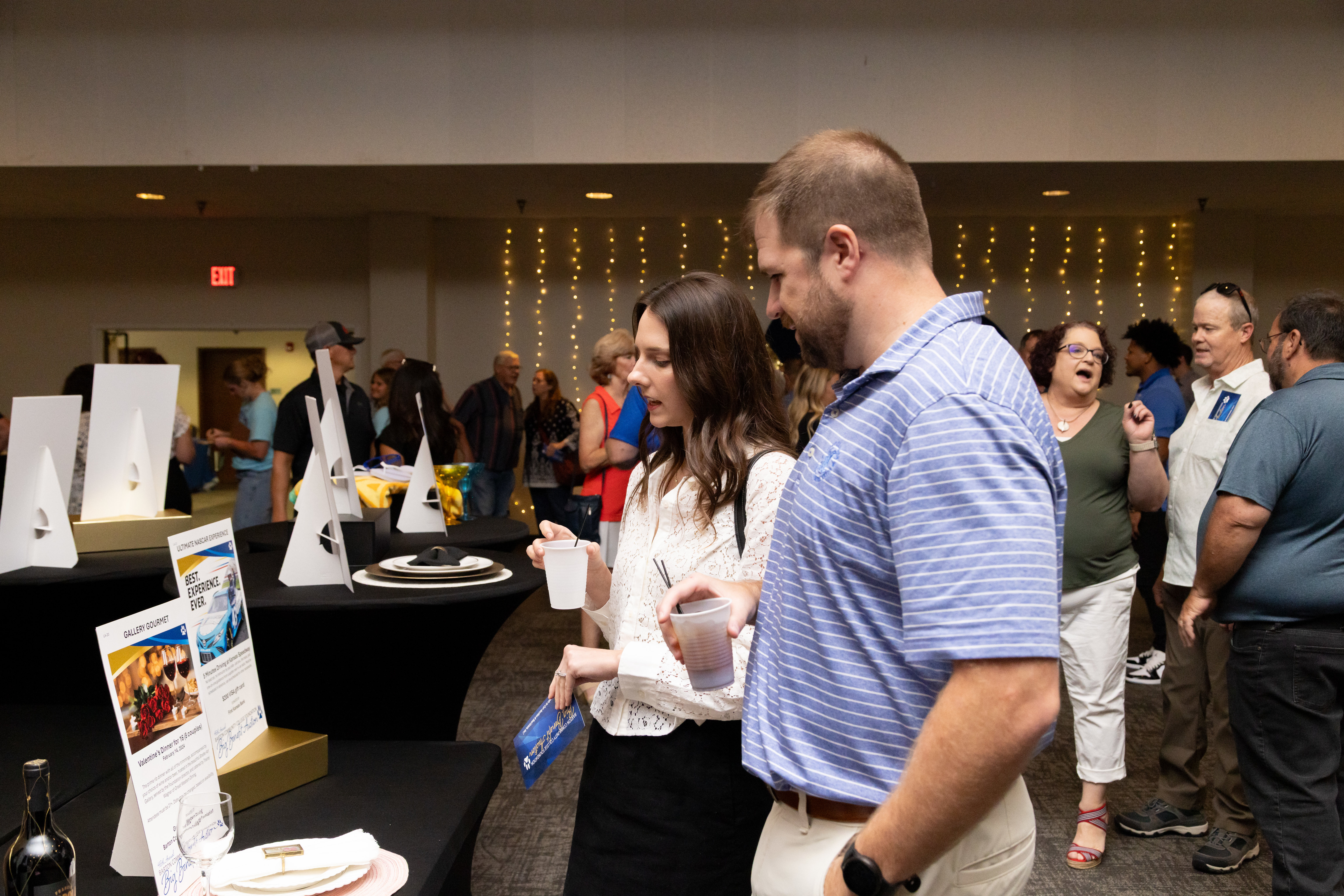 Attendees browse auction items during the Barton Foundation’s 46th Annual Big Benefit Auction