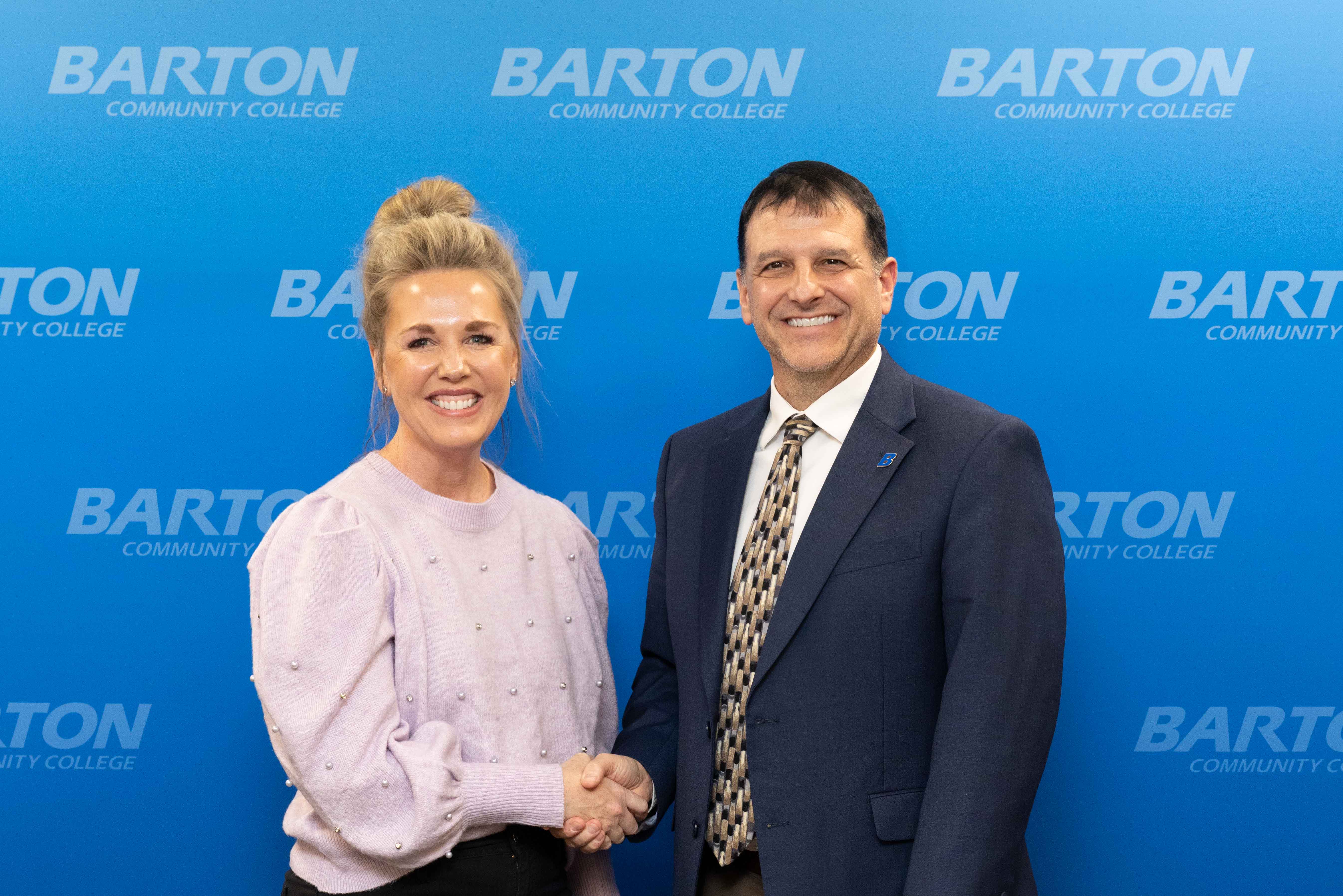 women shaking man's hand