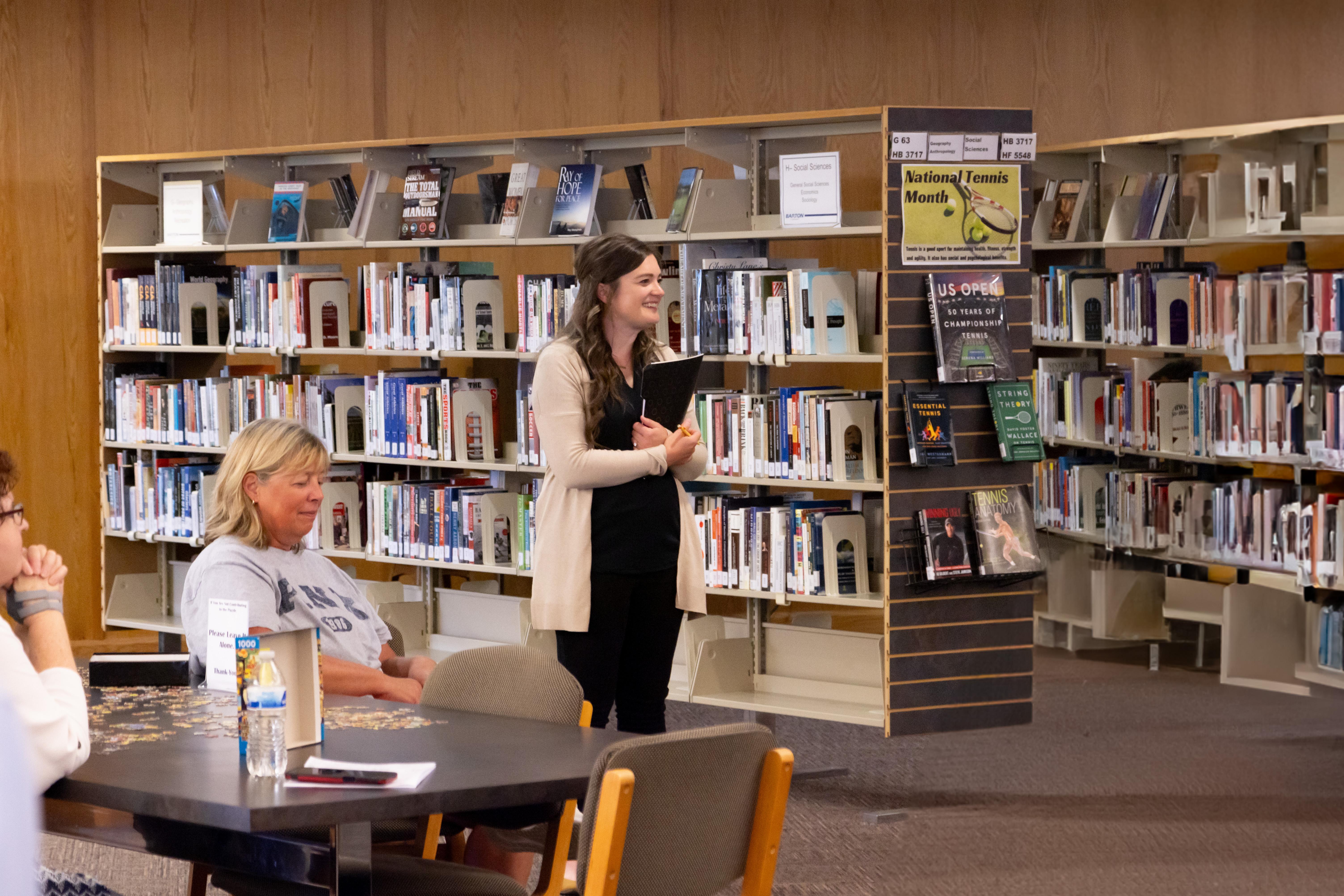 Dr. Kacie Garstecki addresses faculty and staff at the Barton Library Open House, where she was introduced as the college’s first Library Ambassador, a volunteer role focused on outreach and community engagement.