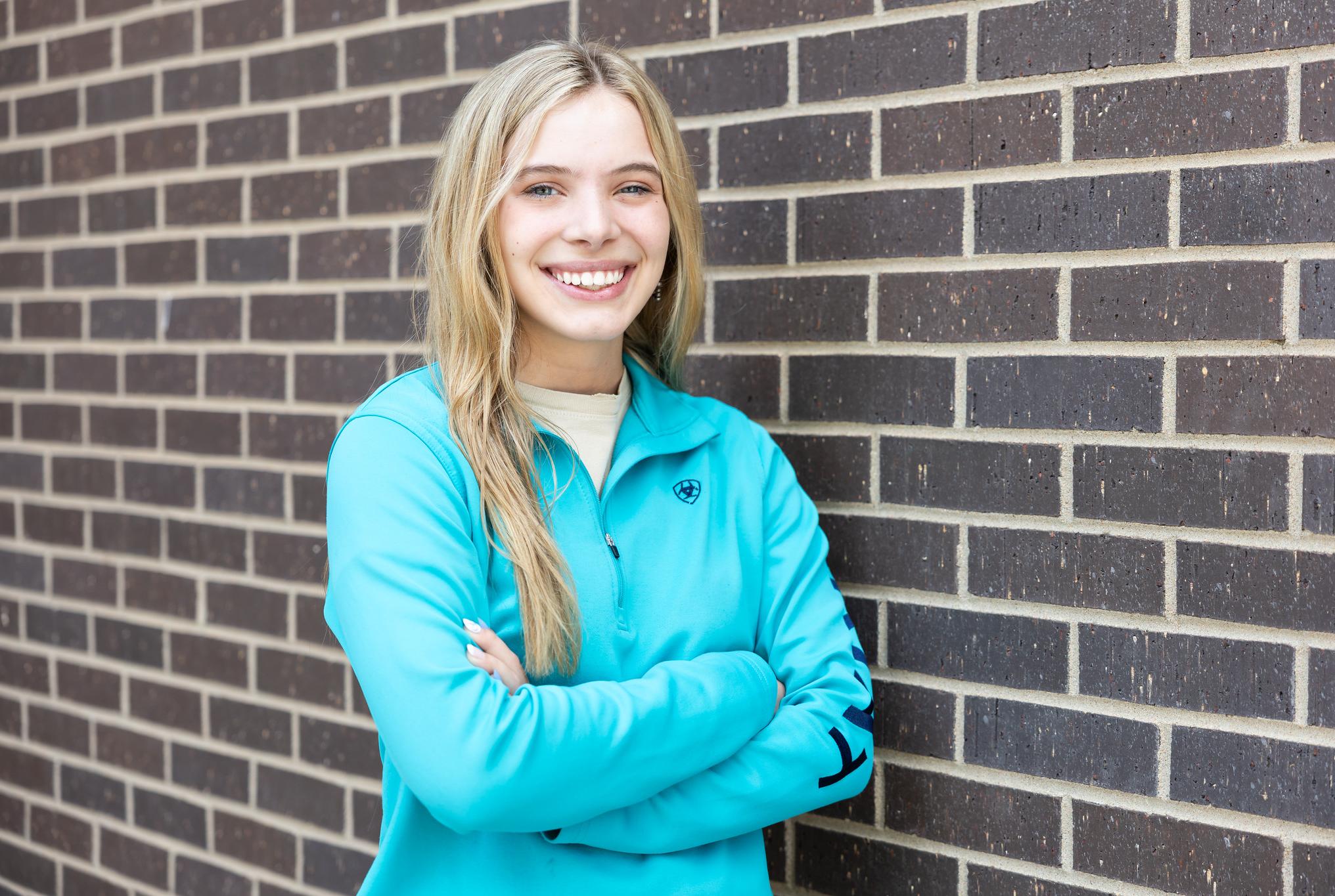 women smiling in teal sweatshirt