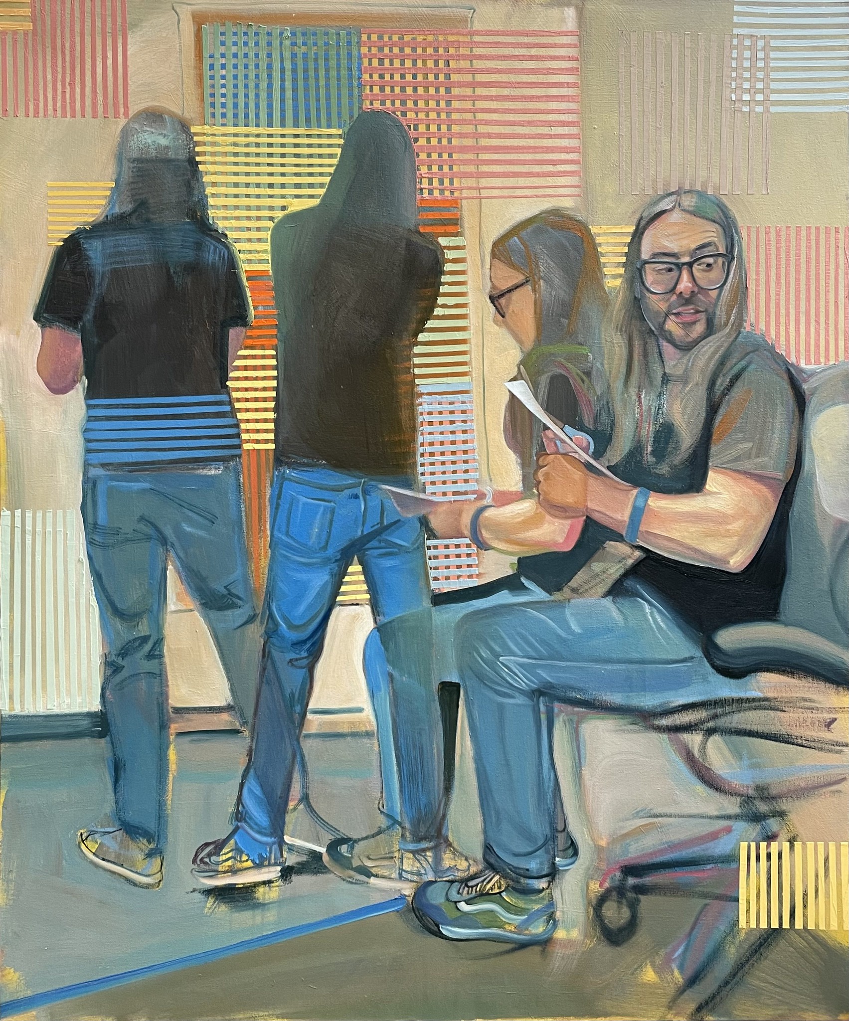Photo of a man painting and looking at paper
