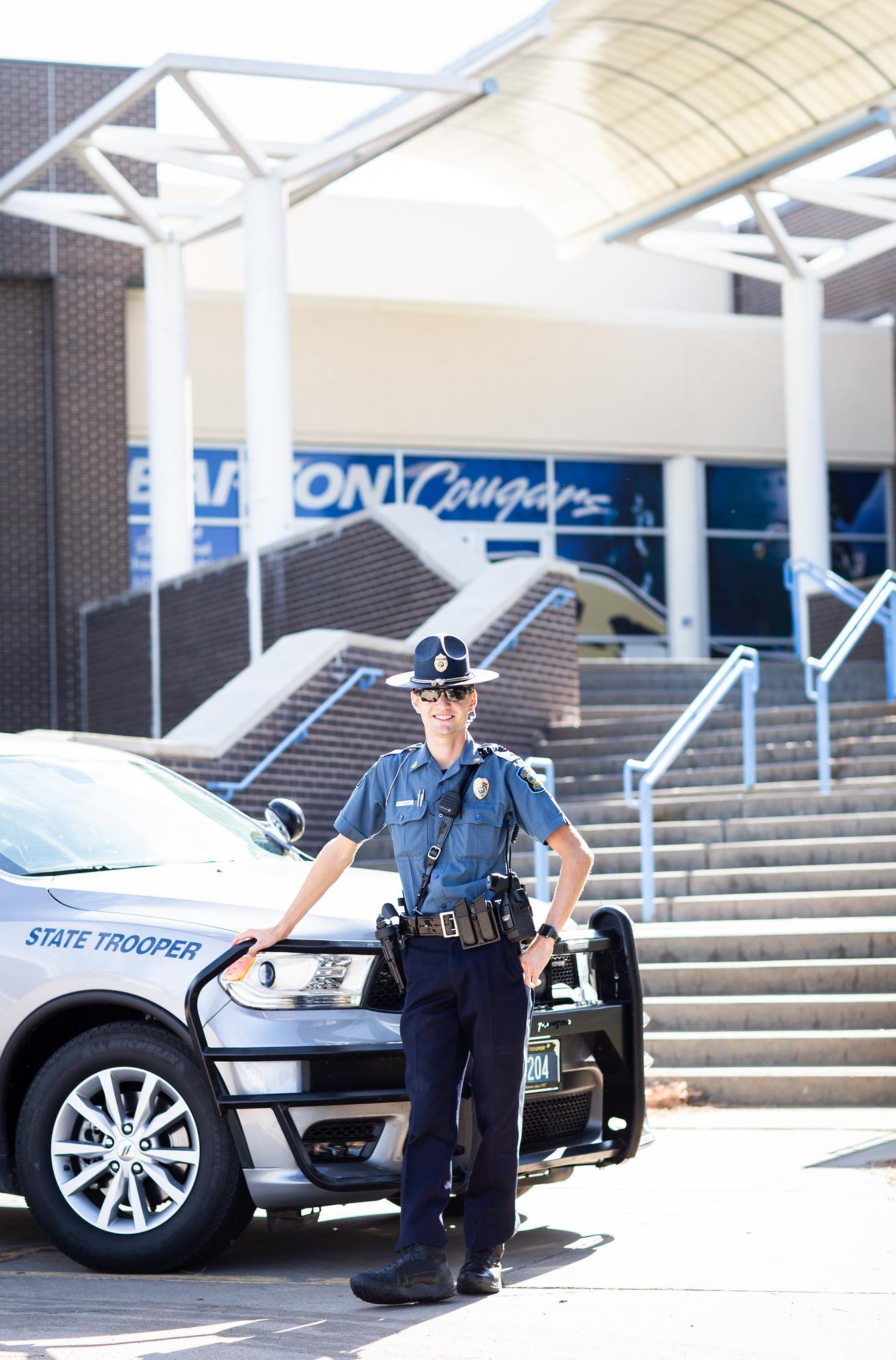 patrolman standing in front of car