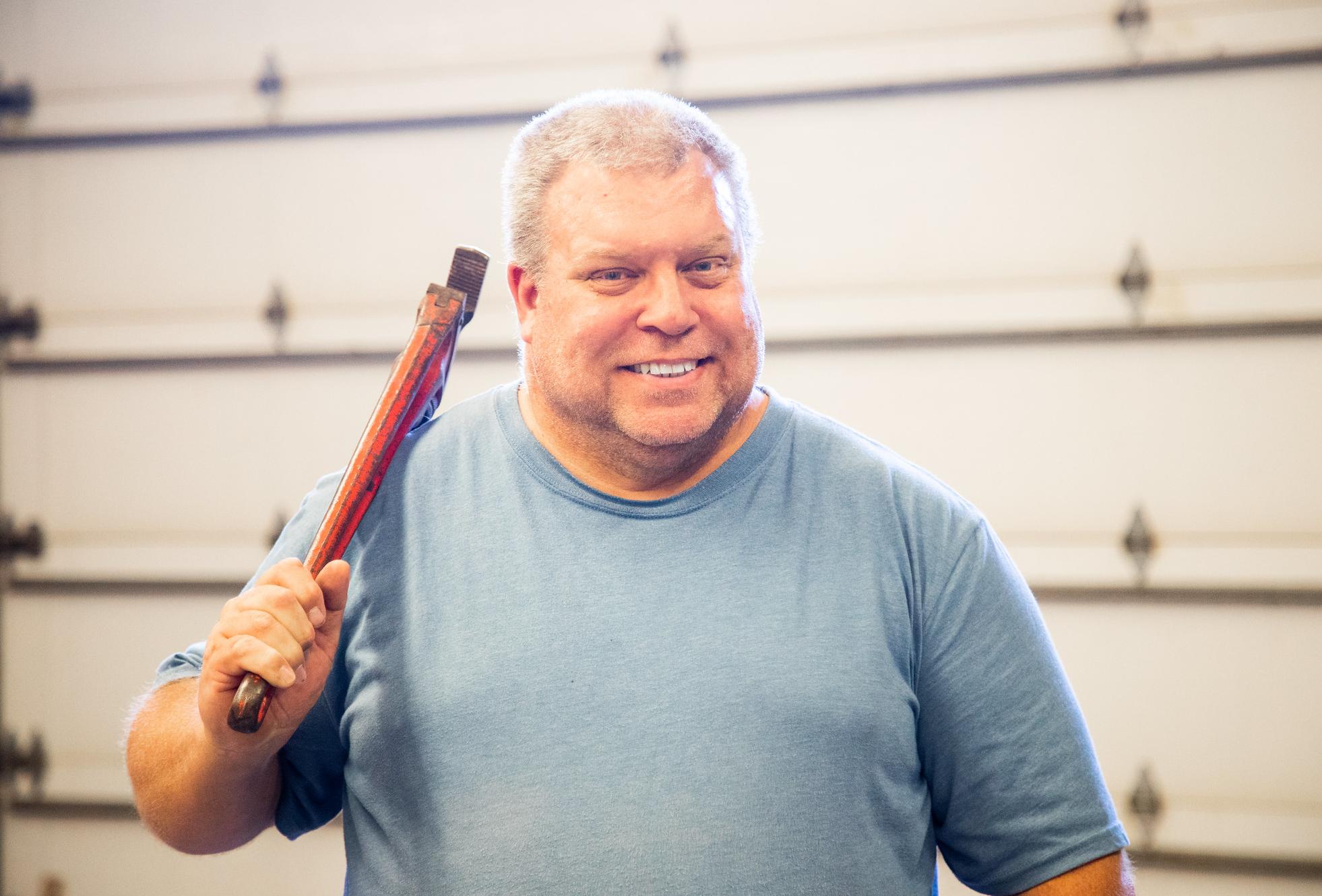Picture of man holding wrench