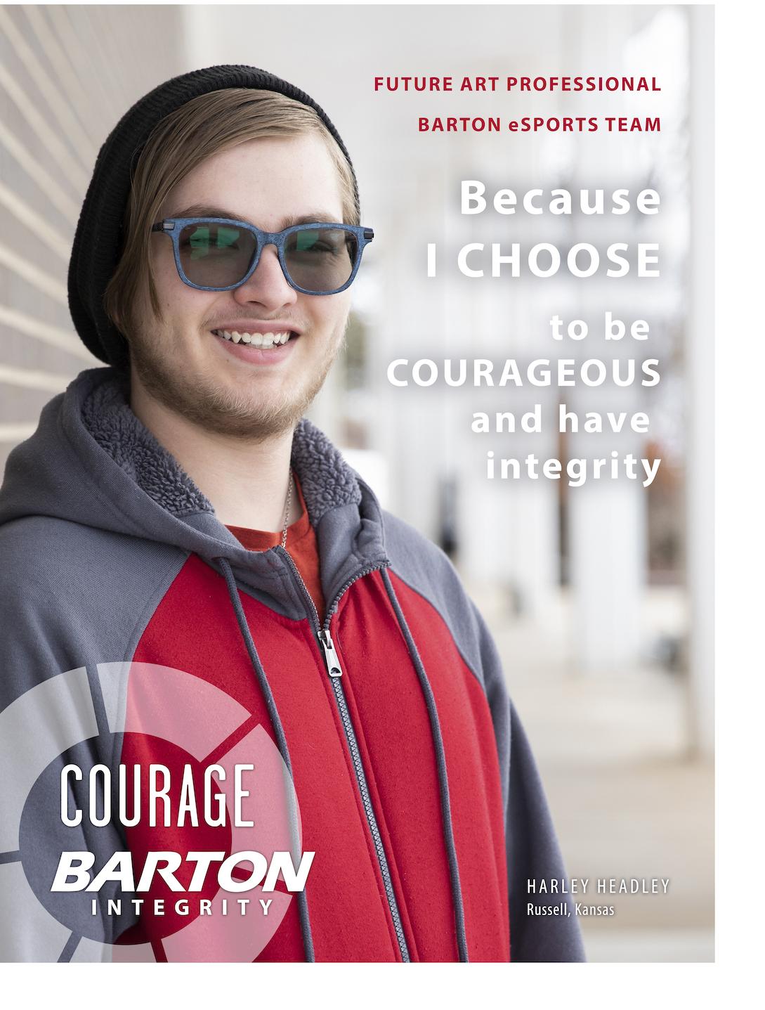 student smiling against a brick wall 