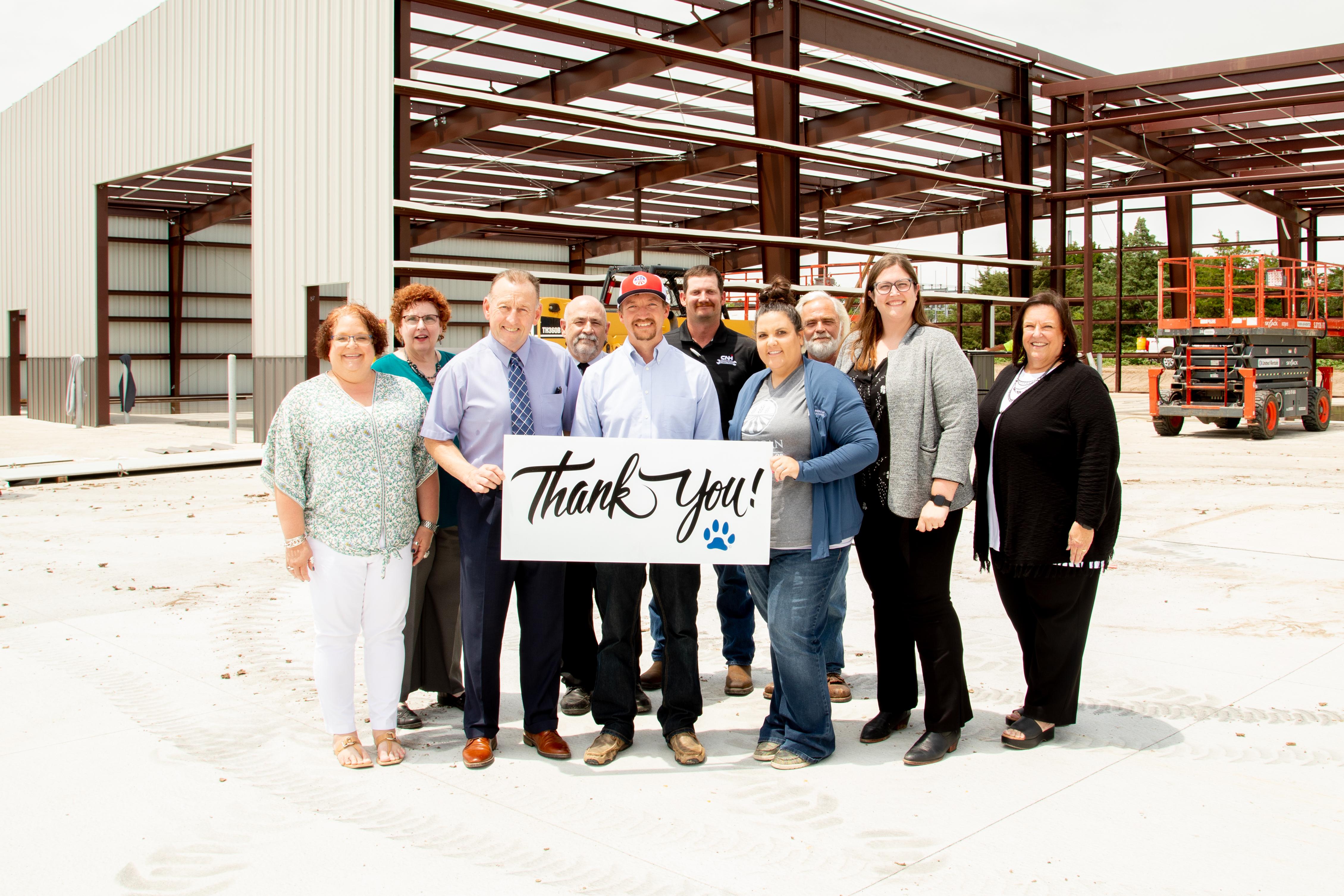 Representatives from American Plains Co-op join the Barton Community College team during the construction of the new Ag and Transportation Complex to mark the beginning of a new partnership with a three-year leadership pledge to the Barton Foundation.