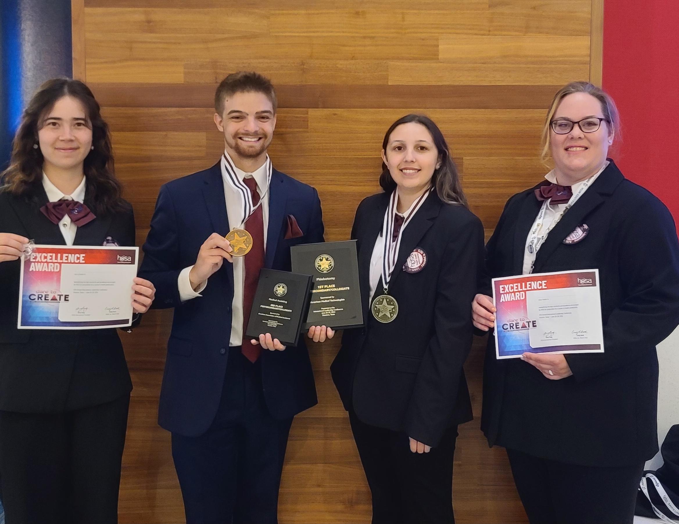 students holding awards