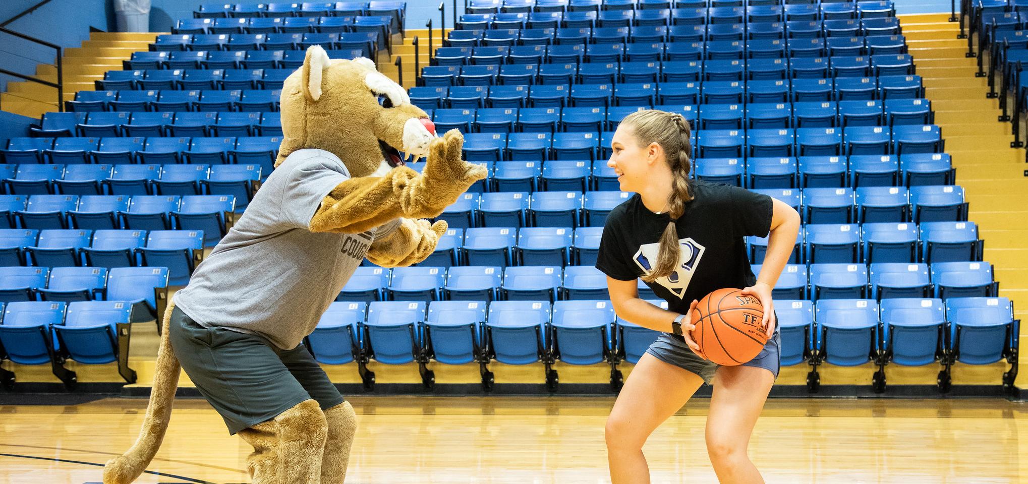 Bart and a student play basketball