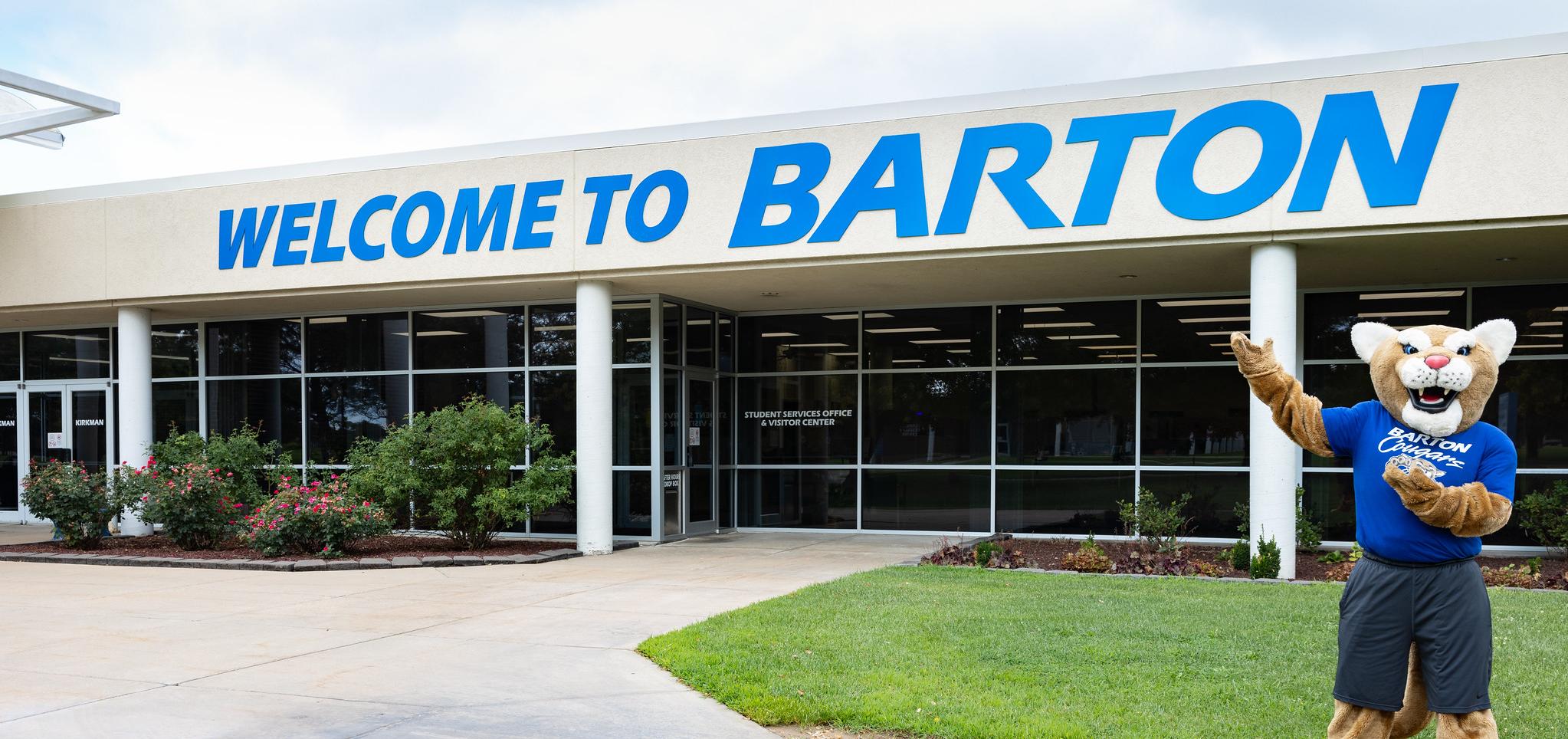Bart gives waves an arm at the Welcome to Barton signage